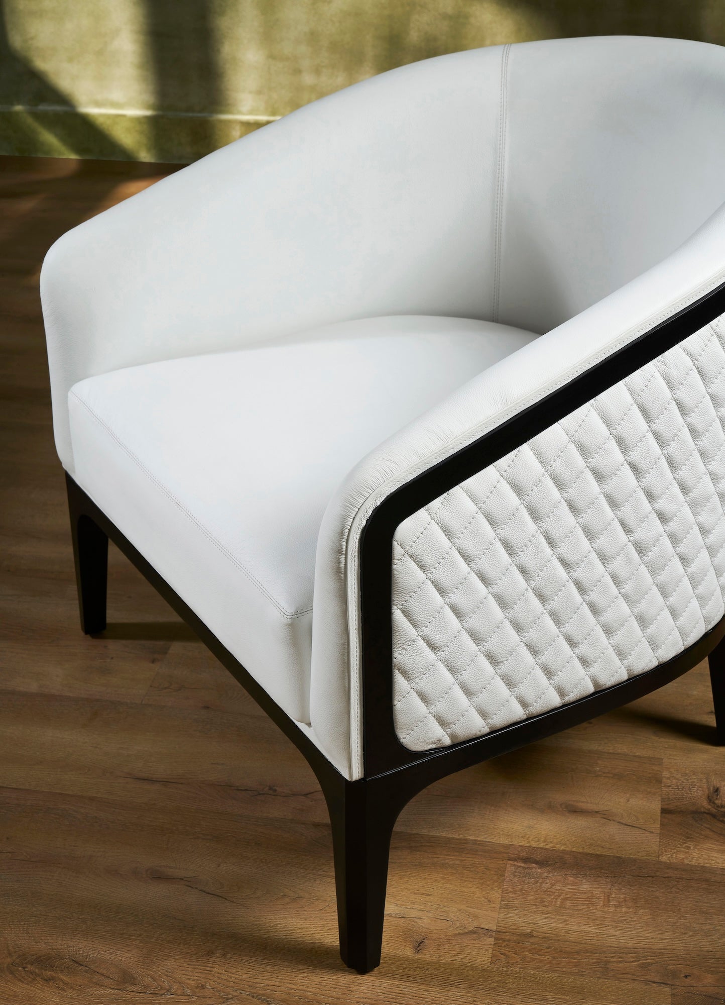 Top-Grain Leather Lounge Chair white diamond quilting side detail hardwood legs angled view 