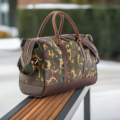 Wanderlust Leather Weekender Tan Camo side profile on wooden bench showing structured sheepskin body dark leather trim and gold hardware detail

