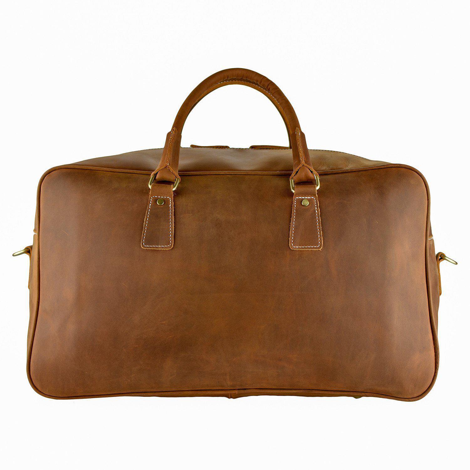 WANDERLUST Roadster leather travel bag British Tan side profile showing clean cowhide silhouette structured base and gold tone hardware detail

