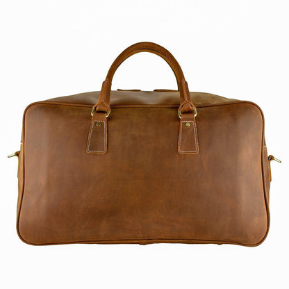 WANDERLUST Roadster leather travel bag British Tan side profile showing clean cowhide silhouette structured base and gold tone hardware detail


