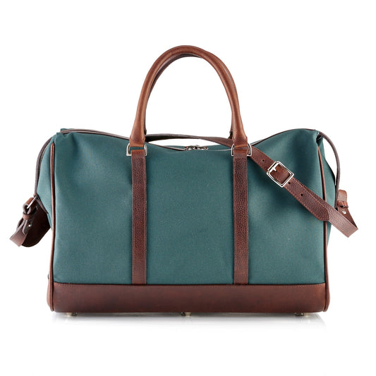 Wanderlust Weekender canvas duffel in Classic Green with dark brown English milled leather trim rolled handles and adjustable shoulder strap

