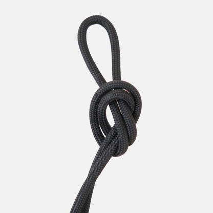 Jet black paracord knot detail of the Wrap hanging kit against a clean white background

